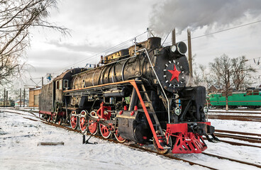 Vintage steam locomotive in winter at Darnytsia Depot in Kyiv, Ukraine