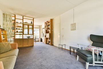 A spacious living room featuring stylish furniture and a warm color palette, complemented by natural light and elegant decor accents.