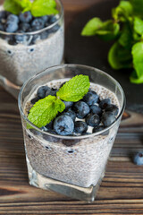 Healthy breakfast or morning with chia seeds vanilla pudding and blueberry berries on table...