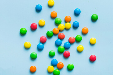 Mixed collection of colorful candy, on colored background. Flat lay, top view. frame of colorful chocolate coated candy