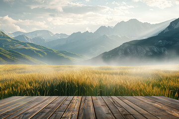A scenic view of a lush green field in the foreground with a wooden platform, leading to a range of mist-covered mountains under a partly cloudy sky, creating a serene and picturesque landscape.