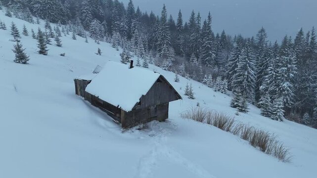 circular shot of an old hut in the mountains in the snow