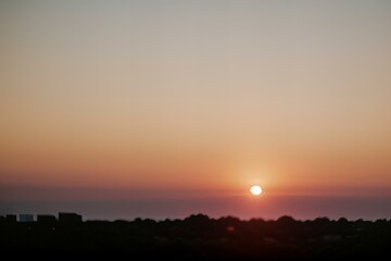 Fototapeta premium Photo Blurred horizon with sun setting and bokeh effect.