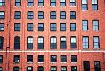 Featuring A brick building facade with intricate details.