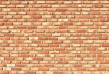 Obraz premium Brick wall with light and shadow patterns.