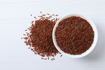 Raw white rice in a bowl on the table
