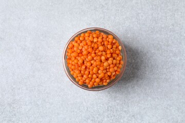 Red lentils in a jar on a gray background