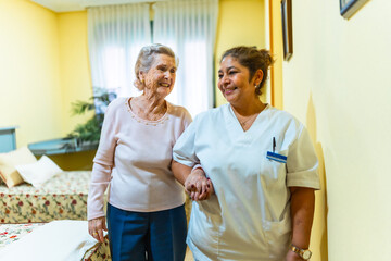 Nurse assisting elderly woman in nursing home