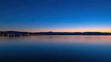 Fototapeta premium Evening sky reflects over the calm tranquil water of the lake