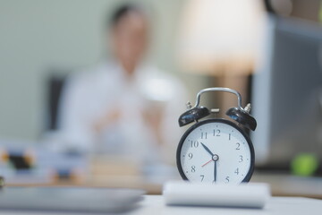 Young adorable Asian businesswoman working with work document during the night, working overtime at...