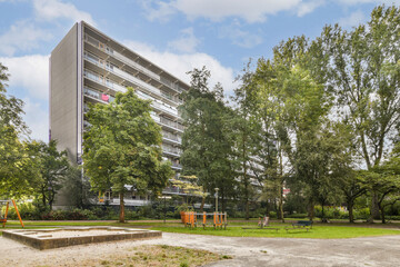 A contemporary residential structure nestled amidst lush trees and open spaces, showcasing modern architecture and urban living blending with nature.