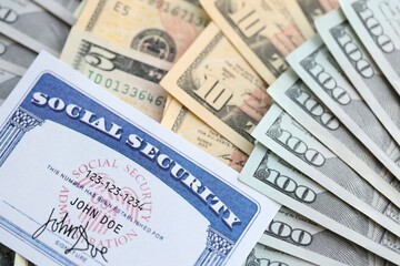 American US dollars money bills and US social security number card close up