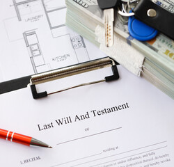 Pen and keys on Last will and testament form and planning blueprints of residential building project