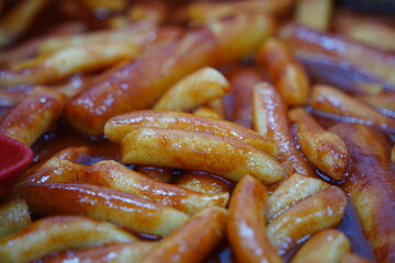 Tteokbokki is a popular Korean dish of chewy rice cakes cooked in a sweet and spicy gochujang sauce.