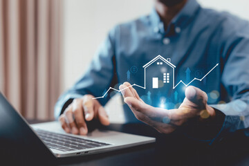Real estate investment concept . Businessman use laptop with house icon for analyzing mortgage loan...