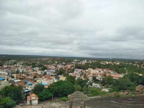 Closeup of beautiful views of a Shravana Belagola village of arch, roads, rock staircase, temple, mountain and hill.