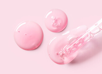 pipette drop of serum test on a light pink background