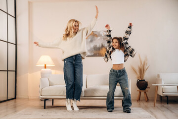 Party, dancing and having fun. Mother and daughter are together in domestic room