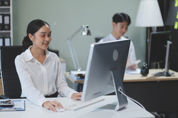 Fototapeta premium Modern Office Businessman Working on Computer. Portrait of Successful Latin IT Software Engineer Working on a Laptop at his Desk. Diverse Workplace with Professionals. Front View Shot