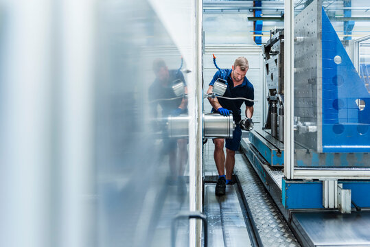 Factory worker repairing machinery in an industrial plant