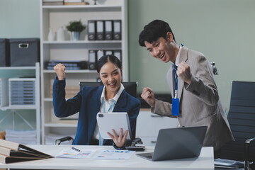 Group of Asia young creative people in smart casual wear discussing business celebrate giving five after dealing feeling happy and signing contract or agreement in office. Coworker teamwork concept.