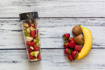 Fresh fruits and smoothie ingredients on rustic table