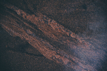 The background is made of brown granite with light veins and a beautiful pattern similar to rivers or mountain slopes. Backgrounds design textures