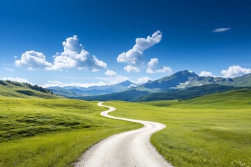 Scenic dirt road winding through rolling green hills under a summer sky