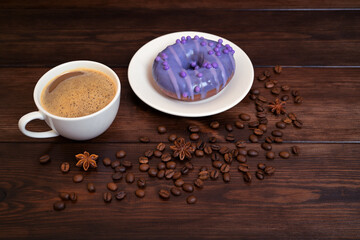 White Cup of Coffee with Purple Donut and Coffee Beans on Wooden Table
