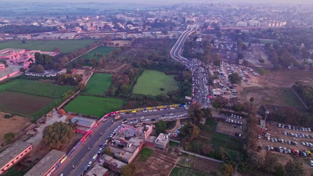 ayodhya dham road with parking area, agricultural land and UDASIN SANGAT RISHI ASHRAM at day time, orbit shot, 4k.