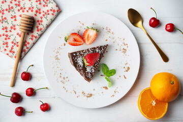 Chocolate cheesecake with fresh strawberries. Top view table.