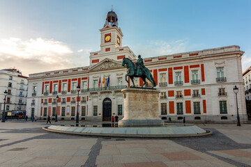 Naklejka premium Post office building and statue of king Charles III on Puerta del Sol square, Madrid, Spain