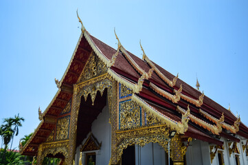 Fototapeta premium Golden Pagoda and Chapel, Lanna Architecture, Symbols of Buddhism, South East Asia at Wat Phra Singh Woramahaviharn, Chiang Mai, Northern Thailand