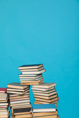 Stacks of books on the blue background of the university library