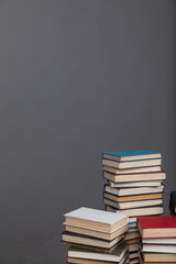 Stacks of old books for teaching in the library on a gray background at school university