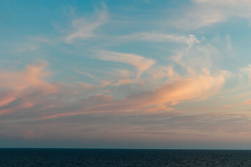 landscape, blue sea and sunset sky with clouds on the horizon