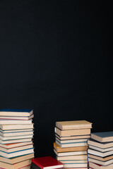 Stacks of old books for studying in the library on a black background of the university