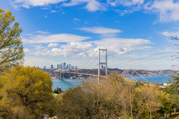Fototapeta premium Istanbul Bosphorus Bridge or 15th July Martyrs Bridge with Istanbul panorama cityscape during summer sunny day. Istanbul, Turkiye