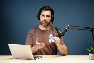 Radio host speaking about prostate cancer during podcast recording