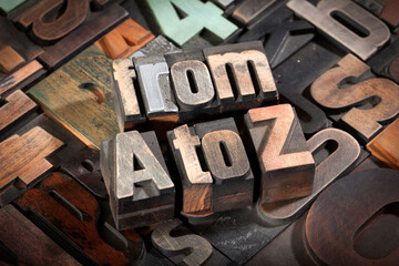 from A to Z, phrase written with antique letterpress printing blocks on random letters background