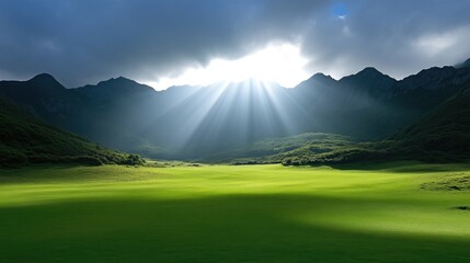 Sunlit valley nestled between mountains. Lush green meadow stretches out beneath a dramatic sky with rays of sunlight piercing through clouds