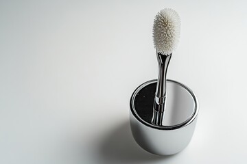 Modern toothbrush on a sleek chrome holder stands out in minimalist decor