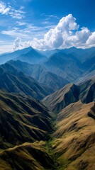 Fototapeta premium Mountain valley landscape under a vivid blue sky. View from high altitude showing a deep valley. Possible use Stock photo for travel and nature websites