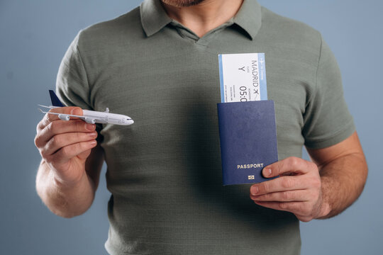 Flying, vacation concept, passport and ticket. Close up view of man against background