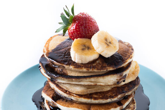 Pancakes with chocolate and fruit  isolated on white background