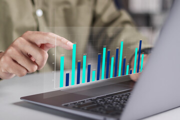 Businessman using laptop to analyze data for business, statistics, banking, financial analysis and profit analysis.