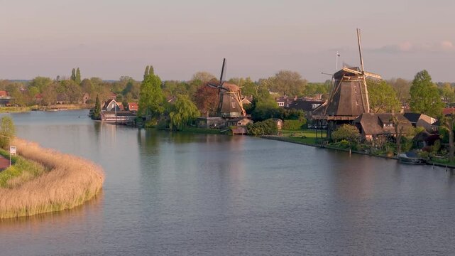 Aerial view of river Vecht and two historical dutch windmills in the city of Weesp