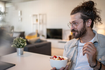 Freelancer enjoying healthy breakfast while working from home