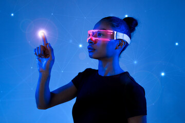 Woman interacting with a holographic interface wearing VR glasses in a futuristic setting