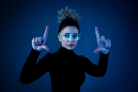 Woman wearing AR glasses in a studio setting with a futuristic theme